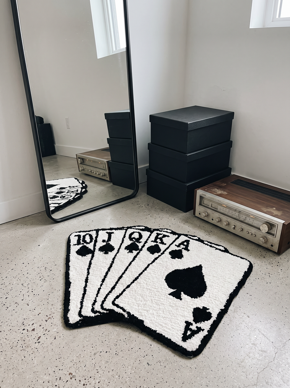 A royal flush playing cards rug on a bedroom floor