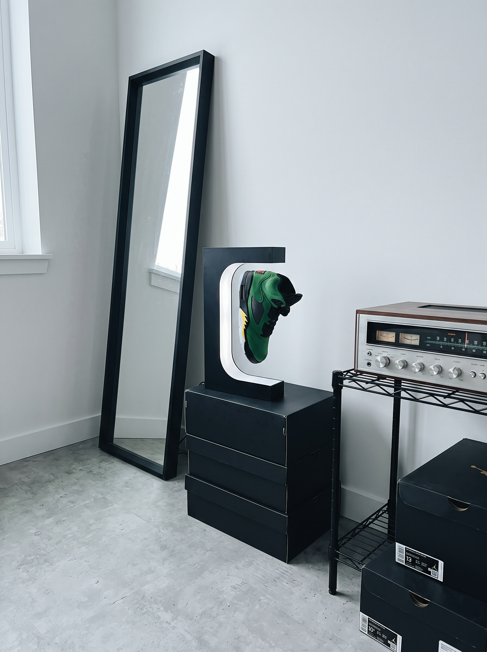 A black levitating sneaker display with a floating shoe