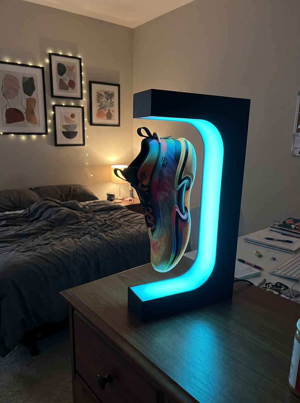 A levitating sneaker display glowing with RGB light on a shelf